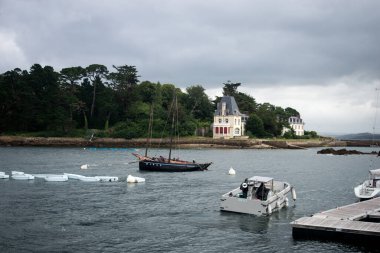 Douarnenez - France - 12 July 2024 - view of sailboat in the sea on cloudy sky background  clipart