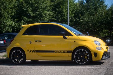 Mulhouse - France - 11 august 2024 - profile  view of yellow Fiat 500 abarth 595 parked in the street  clipart