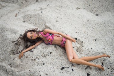 Concarneau - Fransa - 11 Temmuz 2024 - kumsalda pembe bir bikini giyen esmer Barbie bebeğin portresi