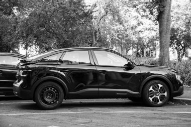 Mulhouse - France - 18 September 2024 - profile view of black citroen C4 electric car parked in the street clipart