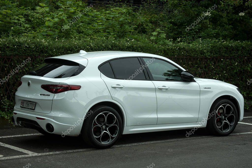 Basel - Switzerland - 20 may 2025 - profile view of white alfa romeo stelvio parked in the street