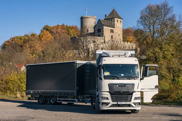 stock image Truck on the background of the castle. Truck with semi-trailer in gray color.  Truck photo for calendar. Car transport . 