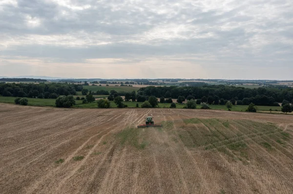 Harvesting field with combine in summer.  Harvest in the field, combine harvester mows grain in Nysa, Poland countryside.  Aerial drone photo of harvester.