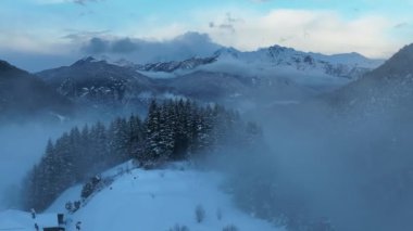 İtalyan Dolomitler 'deki Sisli Şehir' in insansız hava aracı görüntüsü. Alplerdeki İtalyan dağ kasabası Berguzzo. Dolomites Trentino 'daki Adamello Brenta Parkı. İtalyan dağlarında küçük bir kasabada bulutlu bir kış günü. Kışın sisli dağlar.