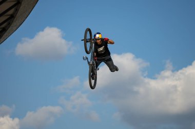 KATOWICE, POLAND - 21 AUGUST 2021: Bicycle Slopestyle World Cup. Red Bull Roof Ride Slopestyle competition in in International Conference Center in Katowice. Slopestyle big jumps, tricks in city.  clipart