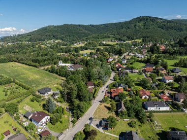 Summer green forest in Jaworze. Drone view in Beskid mountains. Beskid mountains in Jaworze. Drone fly above green mountains in summer. Polish green mountains and hills aerial drone photo clipart