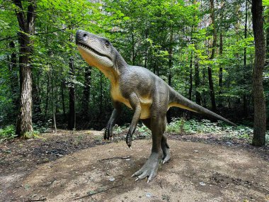 Archozaur dinosaur. Realistic figure of an Archozaur dinosaur inforest park in Kazimierz Sosnowiec. Prehistoric predator fascinating element of the landscape. Wawel Dragon. Dragon from Lisowice. clipart