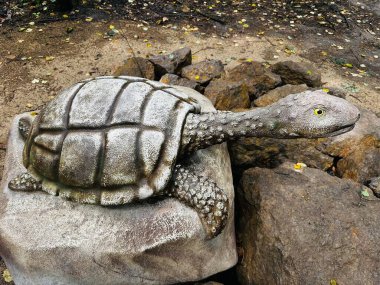 Turtle dinosaur. Realistic figure of an Turtle dinosaur inforest park in Kazimierz Sosnowiec. Prehistoric predator create a fascinating element of the landscape, attracting dinosaur lovers. clipart