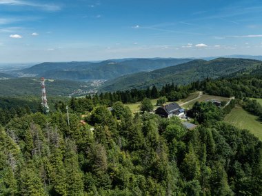 Stunning aerial drone view of summer green forests in the Beskids, Bielsko Biala, Magurka Wilkowicka. Shelter on Magurka Wilkowicka. The landscape of the hills reflects the beauty and serenity of lush greenery.  clipart