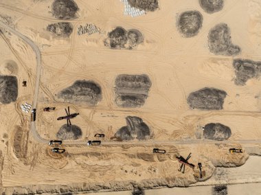 Quarrying sand. Machines and truck working on sand mine. Mining quarry open pit excavation sand mine. Aerial drone view of a sand mine in the forest. Loader Loading Sand Into Dump Truck In Sand Pit.  clipart