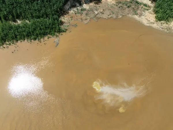 stock image Lake District, swallow hole flooded as a result of the mining damage Pomorzany mine in Olkusz,Poland. Aerial drone view of flooded sand pit. Forest submerged in a lake. Sunken sandpit with clear water. 