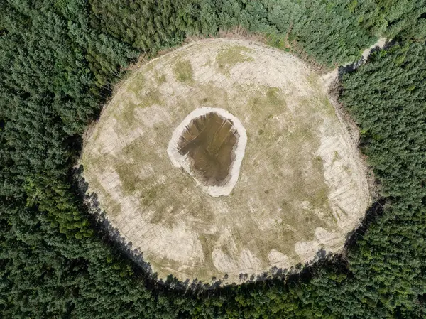 stock image Lake District, swallow hole flooded as a result of the mining damage Pomorzany mine in Olkusz,Poland. Aerial drone view of flooded sand pit. Forest submerged in a lake. Sunken sandpit with clear water. 