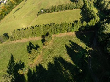 Little Beskids mountain range.Aerial drone view of Rzyki Village in Beskid Maly Poland.Beskid Maly aerial panorama of potrojna hill and czarny gron.Czarny gron ski resort in Rzyki, Andrychow, Poland. clipart