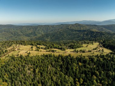 Little Beskids mountain range.Aerial drone view of Rzyki Village in Beskid Maly Poland.Beskid Maly aerial panorama of potrojna hill and czarny gron.Czarny gron ski resort in Rzyki, Andrychow, Poland. clipart