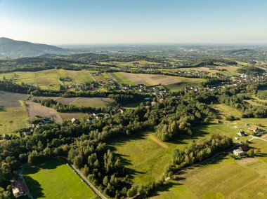 Little Beskids mountain range.Aerial drone view of Rzyki Village in Beskid Maly Poland.Beskid Maly aerial panorama of potrojna hill and czarny gron.Czarny gron ski resort in Rzyki, Andrychow, Poland. clipart