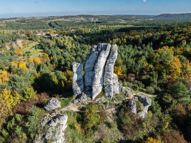 Limestone rock surrounded by autumn forest.Aerial drone view of Rzedkowice limstone Rocks.Group of rocks in Rzedkowice town. Jurassic limstone rocks in Poland. Jura Krakowsko - Czestochowska, Poland. clipart