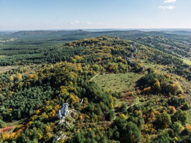 Limestone rock surrounded by autumn forest.Aerial drone view of Rzedkowice limstone Rocks.Group of rocks in Rzedkowice town. Jurassic limstone rocks in Poland. Jura Krakowsko - Czestochowska, Poland. clipart