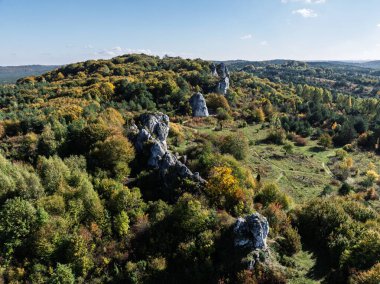 Limestone rock surrounded by autumn forest.Aerial drone view of Rzedkowice limstone Rocks.Group of rocks in Rzedkowice town. Jurassic limstone rocks in Poland. Jura Krakowsko - Czestochowska, Poland. clipart