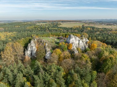 Aerial drone view of stronghold on Birow Hill. Limestone rock hill in autumn. Reconstructed stronghold on Birow Hill in the Czestochowa Upland in the village of Podzamcze,Ogrodzieniec, Poland.  clipart