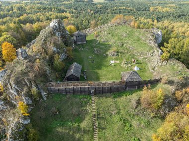 Aerial drone view of stronghold on Birow Hill. Limestone rock hill in autumn. Reconstructed stronghold on Birow Hill in the Czestochowa Upland in the village of Podzamcze,Ogrodzieniec, Poland.  clipart