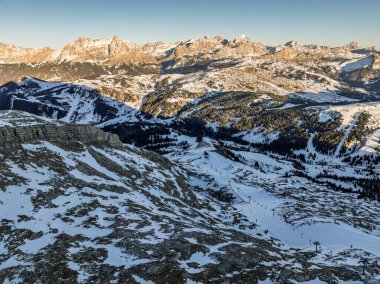 Sella Ronda group. Italian Dolomites drone aerial view in winter snow ski sunny days. Sella Ronda Marmolada .Aerial landscape of snowy Italian Alps Dolomites with Sella group in front and Marmolada. clipart