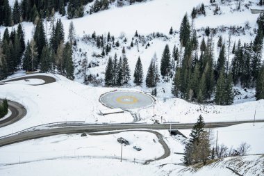 Helicopter on a snowy mountain helipad with a picturesque alpine backdrop. Helicopter, sightseeing flights over the Dolomites and Alps. Helicopter is standing on a landing field in the mountains. clipart