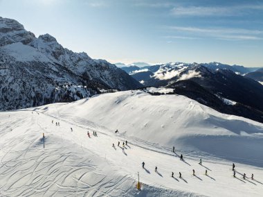 Dolomitler ve alpler içinde güneşli kışın insansız hava aracı görüntüsü. Pinzolo köyü ve İtalya 'da bir kayak merkezi. Dolomites Brenta, Adamello park Presanella moutain, Doss del Sabion skiarea trentino Italy.