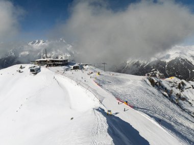 Aerial drone view of sunny winter in dolomites, alps. Pinzolo village and a ski resort in Italy. Dolomites Brenta, Adamello park Presanella moutain, Doss del Sabion skiarea trentino Italy. clipart