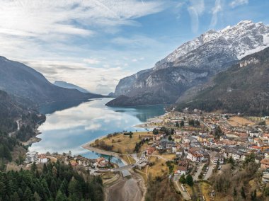 Aerial drone view of Lake Molveno, beautiful lake in Italy. Lake in dolomites from drone in sunny winter. Lake Molveno in Brenta Dolomites. The mountains along the Molveno Lake, Trentino, Italy.