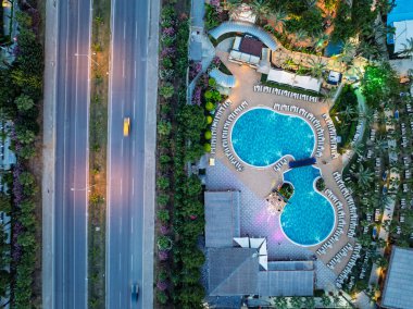 Türkiye 'nin Alanya kentindeki Türkler üzerinde gece karanlığına muhteşem hava günbatımı. Alanya kıyı şeridi, tatil beldeleri, marina, oteller ve Akdeniz insansız hava aracı manzaralı şehir ışıkları. Akdeniz kıyı şeridi