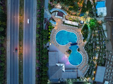 Türkiye 'nin Alanya kentindeki Türkler üzerinde gece karanlığına muhteşem hava günbatımı. Alanya kıyı şeridi, tatil beldeleri, marina, oteller ve Akdeniz insansız hava aracı manzaralı şehir ışıkları. Akdeniz kıyı şeridi