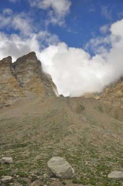 Morning view of Rocky mountains of Ladakh region covered with clouds from peak in summer.