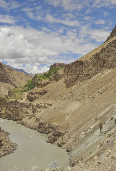 stock image Beautiful view of flowing river in between  rocky mountains with clouds in the sky on the way of Padum, Zanskar, Ladakh, INDIA 