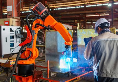 Robotic Welding Machine, Technicians Welding a Steel Plate of Steel Structure with Robotic Welding or Robotic Arm Welding at Industrial Factory.