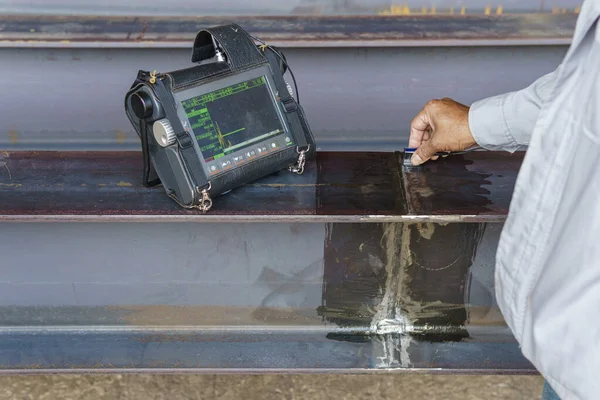 Inspectors are Inspection defects in Welded Steel H-beam add joints with Process Ultrasonic Testing (UT) of Non-Destructive Testing (NDT)