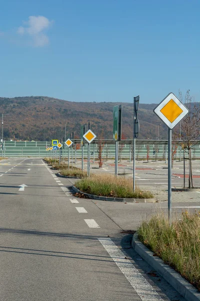 stock image International road signs 'Main road' or 'Priority road' in a row. Many  yellow squares signs.