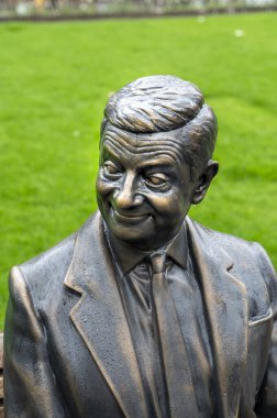 London, UK - March 22, 2024 : Statue of Mr Bean sitting on a bench. Rowan Atkinson bronze statue in London. UK. clipart