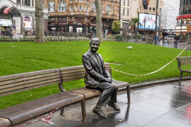 London, UK - March 22, 2024 : Statue of Mr Bean sitting on a bench. Rowan Atkinson bronze statue in London. UK. clipart