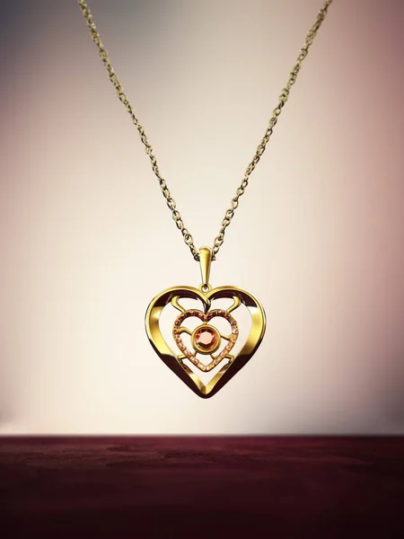 Gold heart necklace decorated with ruby gemstones.