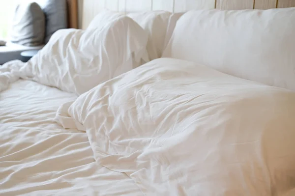 white pillows on crumpled bed