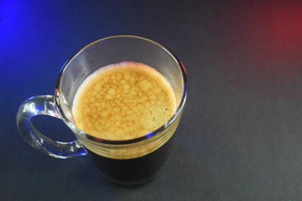 black coffe on black table with neon lights