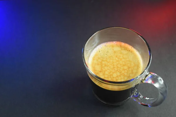 black coffe on black table with neon lights