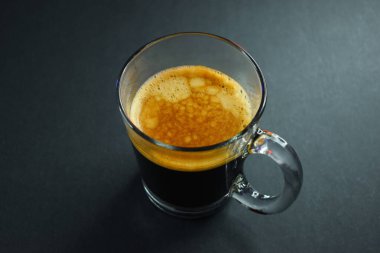 Siyah masada sıcak sade kahve, sabah içeceği.