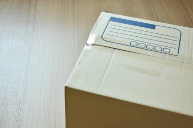brown post box packaging put on wood floor for shipping, paper texture