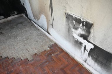 old scary interior burn house, cement wall and wood floor