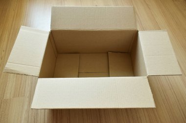 brown post box packaging put on wood floor for shipping, paper texture