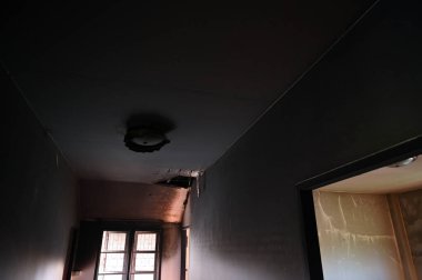 burn interior house with window and cement wall, old scary home