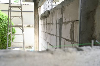 interior construction industry with steel ladder cement wall texture background