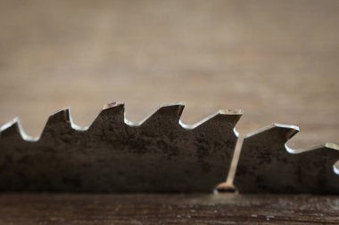 sharp metal saw on wood plank texture background, construction machine