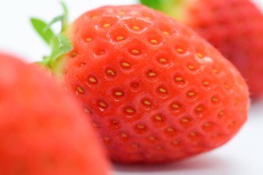 beautiful three fresh red strawberry isolated on white background